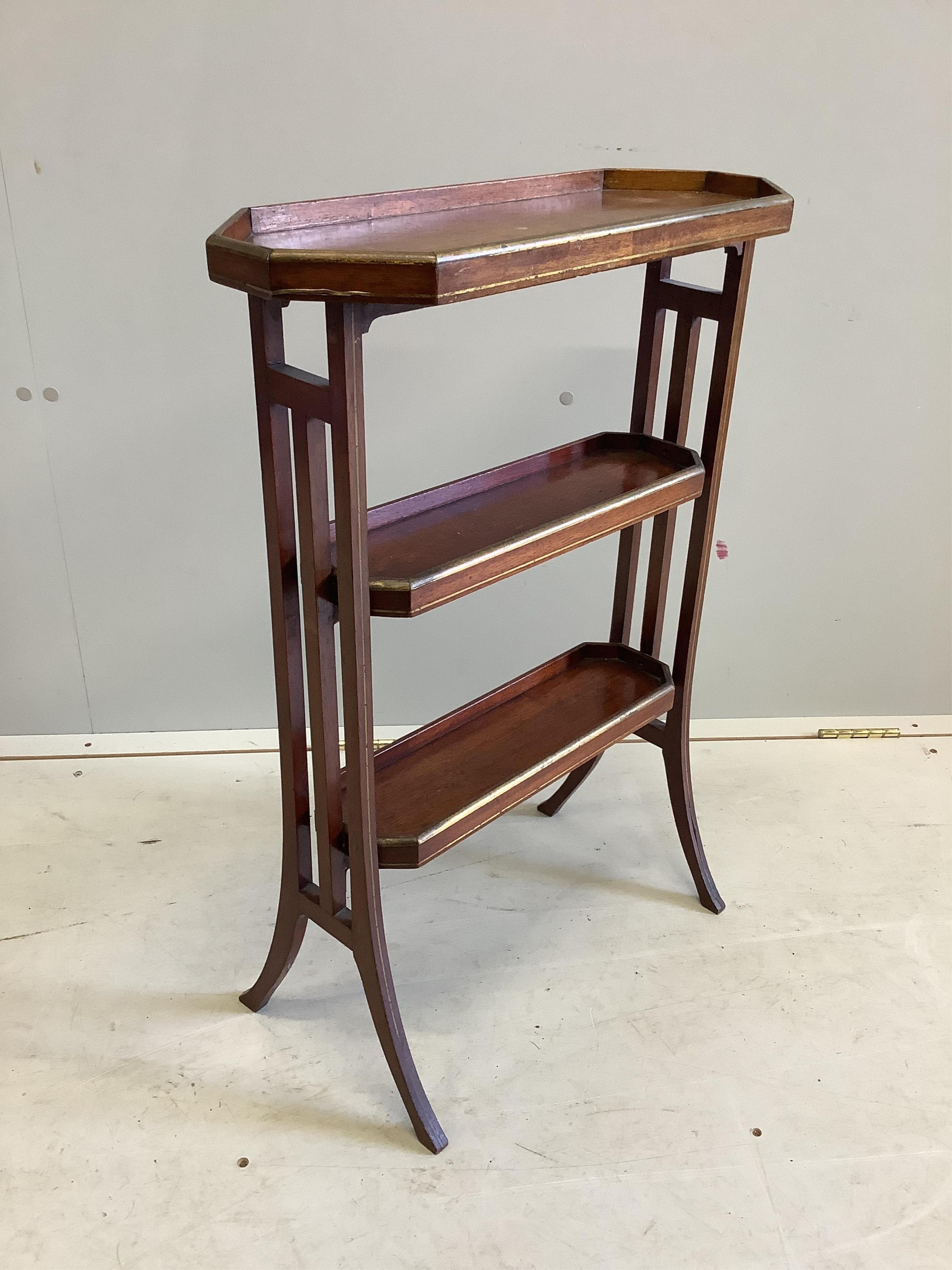 An Edwardian gilt metal mounted mahogany three tier table, width 51cm, depth 20cm, height 73cm. Condition - fair